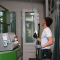Ein Glasbautechniker arbeitet in einer Werkstatt mit Glas.